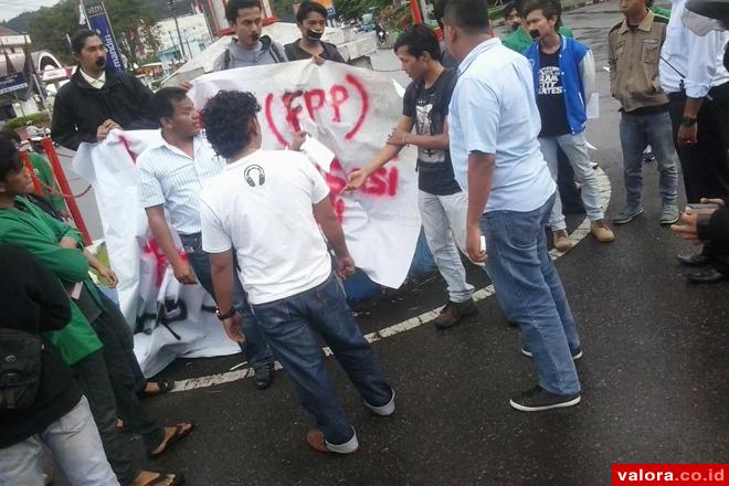 Sejumlah personel kepolisian berpakaian sipil, mendatangi massa FPP yang menggelar demo menentang liberalisasi pendidikan pada Hari Hardiknas, Sabtu (2/5/2015). Demo damai ini digelar di depan bundaran Jl M Yamin, Padang. (@LAMPKFHUA)