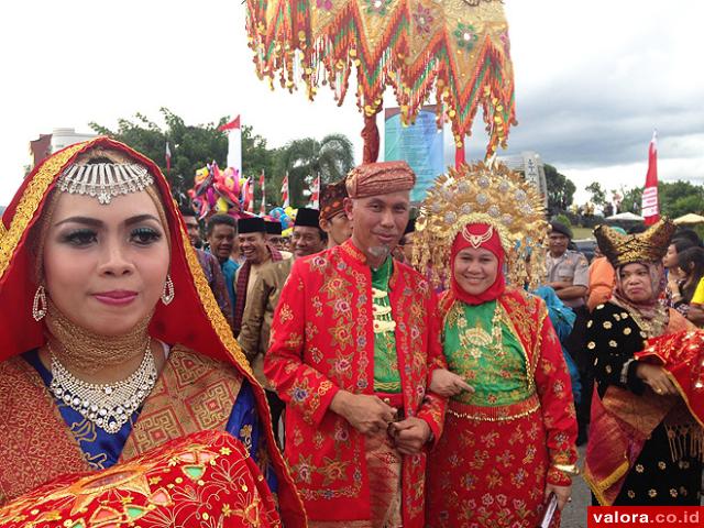 Masyarakat Ambon dan perantau Minang, antusias menyambut kontingen pawai budaya Kota Padang dalam rangkaian kegiatan Rakernas APEKSI di Kota Ambon, Rabu (6/5/2015). Dalam pawai budaya ini, Walikota Padang H Mahyeldi dan isteri menjadi model sepasang penga