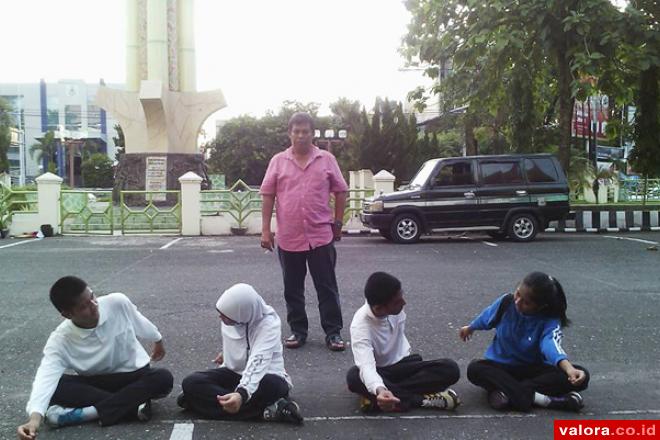 Kasi Kepemimpinan dan Tenaga Kepemudaan Dispora Sumbar, Hendri Budi Utama, tengah memerhatikan empat orang siswa asal Sumbar latihan menari, saat latihan di halaman Dinas Pendidikan dan Kebudayaan Sumbar, Jl Sudirman, 17 Mei 2015. (istimewa)