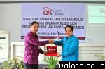 Kepala Kantor OJK Wilayah Sumbar, Indra Yuheri, berikan plakat OJK kepada Sekdako Payakumbuh, Benni Warlis dalam sosialisasi Otoritas Jasa Keuangan (OJK) dan LKM di Payakumbuh, Kamis (5/11/2015). (humas)