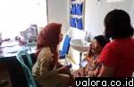 MELAYANI-Seorang petugas Puskesmas Agam melayani pasien