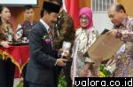 Bupati Solsel, Muzni Zakaria menerima penghargaan Swasti Saba kategori Padapa dari Dr Pattiselano Roberth Johan, Mars, Staf Ahli Bidang Desentralisasi Kesehatan dan Sertifikat Swasti Saba Padapa, di gedung Sasana Bakti Paraja, Kemendagri, Selasa (28/11/20