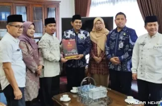 Ketua KPU Agam, Suhendra, serahkan Surat Keputusan (SK) penetapan bupati dan wakil bupati terpilih hasil pemilihan serentak 2024 pada Ketua DPRD Agam, Ilham, di ruang kerja pimpinan dewan, Jumat. (humas)