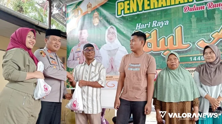 Kapolres Pasaman Barat AKBP Agung Tribawanto menyerahkan daging kurban pada warga sekitar Mapolres, usai penyembelihan, Sabtu. (robbi irwan)