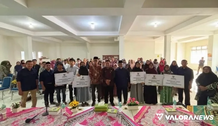 Ketua Baznas Bukittinggi, Edi Syahmian bersama Rismal Hadi (Sekda) salurkan zakat periode Juni 2025 pada mustahik yang berhak di kantor balai kota, Kamis. (humas)