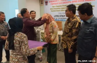Pemasangan tanda peserta pada salah seorang anggota DPRD Padang yang mengikuti kegiatan Bimtek peningkatan pelayanan publik, di Jakarta, Rabu. (humas)