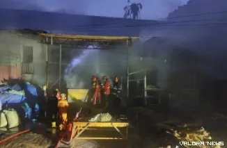 Petugas Damkar Kota Padang memadamkan kobaran api yang menjilati gudang pembakaran kopra di kawasan Seberang Padang, Senin sore. (humas)