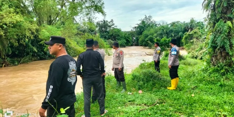 Sejumlah aparat kepolisian beserta lainnya menyisir aliran sungai guna mencari korban terrbawa arus di Lubuk Kubang Alahan Kasai. Dok.